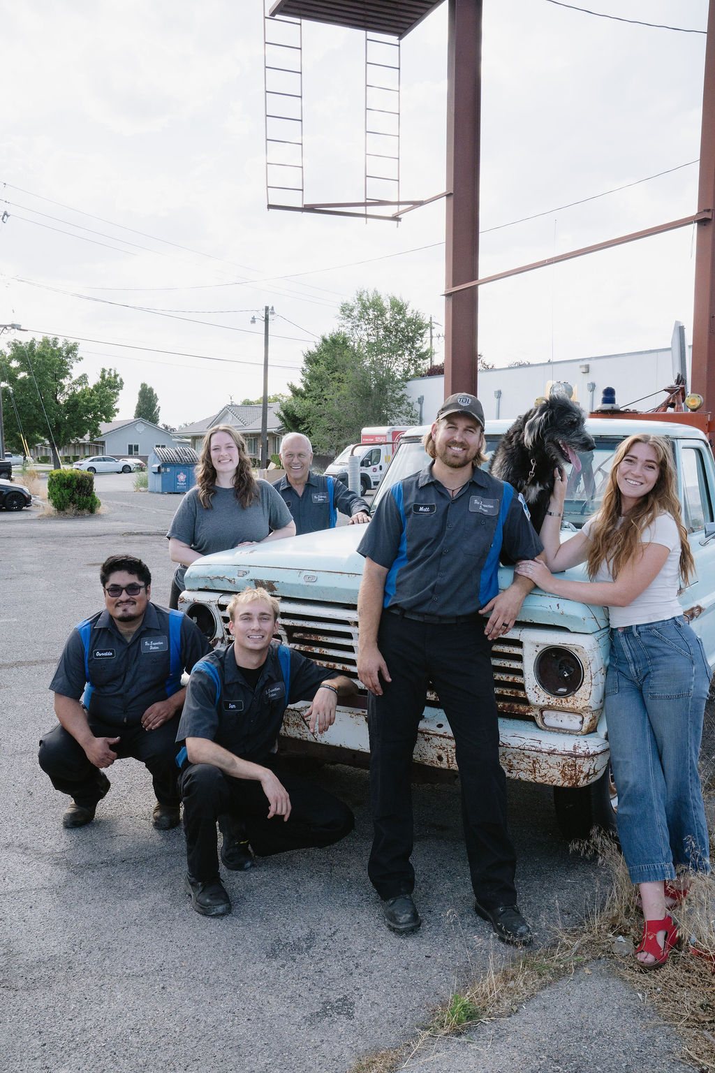 The Inspection Station team with an old pickup truck outside the shop